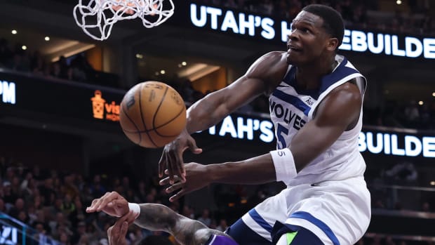 Anthony Edwards throws down a dunk over Jazz forward John Collins.
